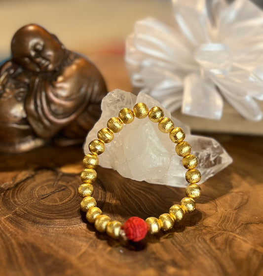 Brushed gold copper with a red Mantra bead